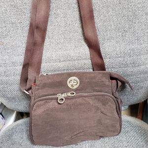 Baggallini Bag with multiple pockets..Dark Brown/Black with Red interior.